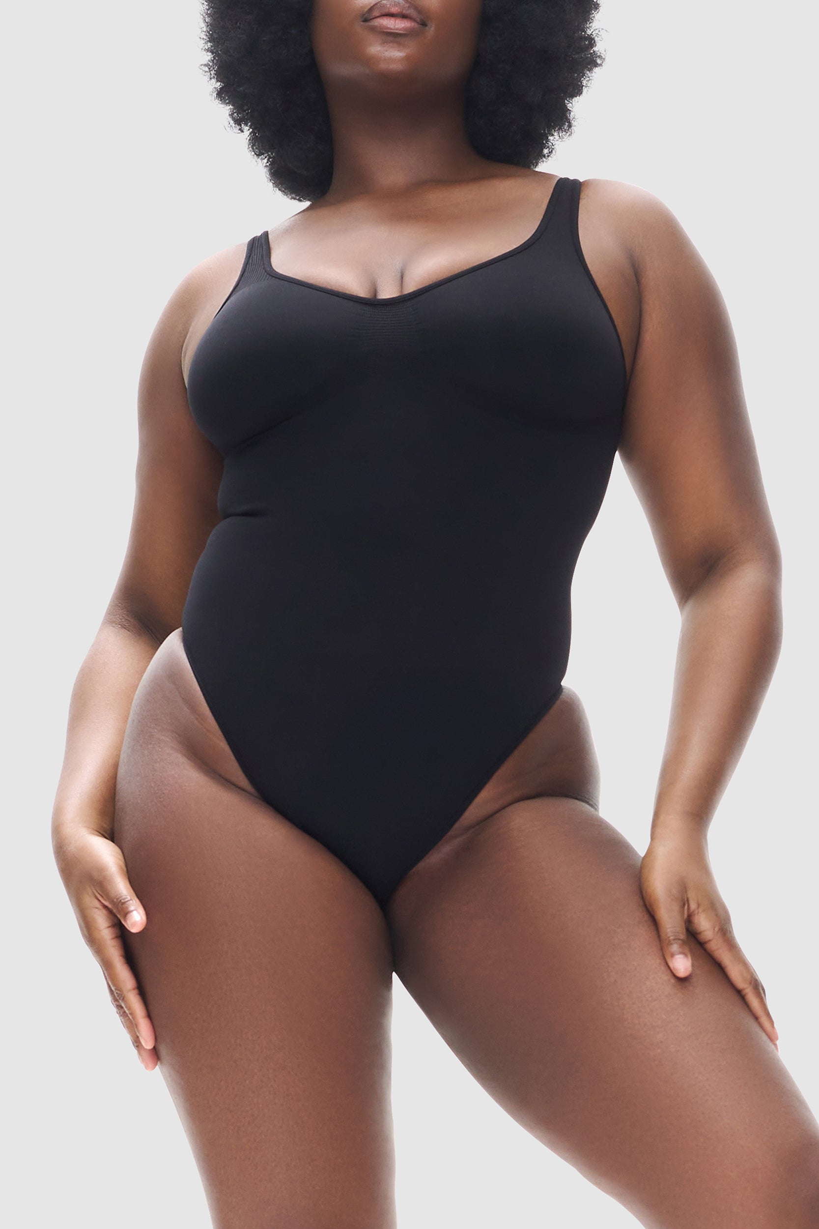 Black seamless thong body with compression and bust support.