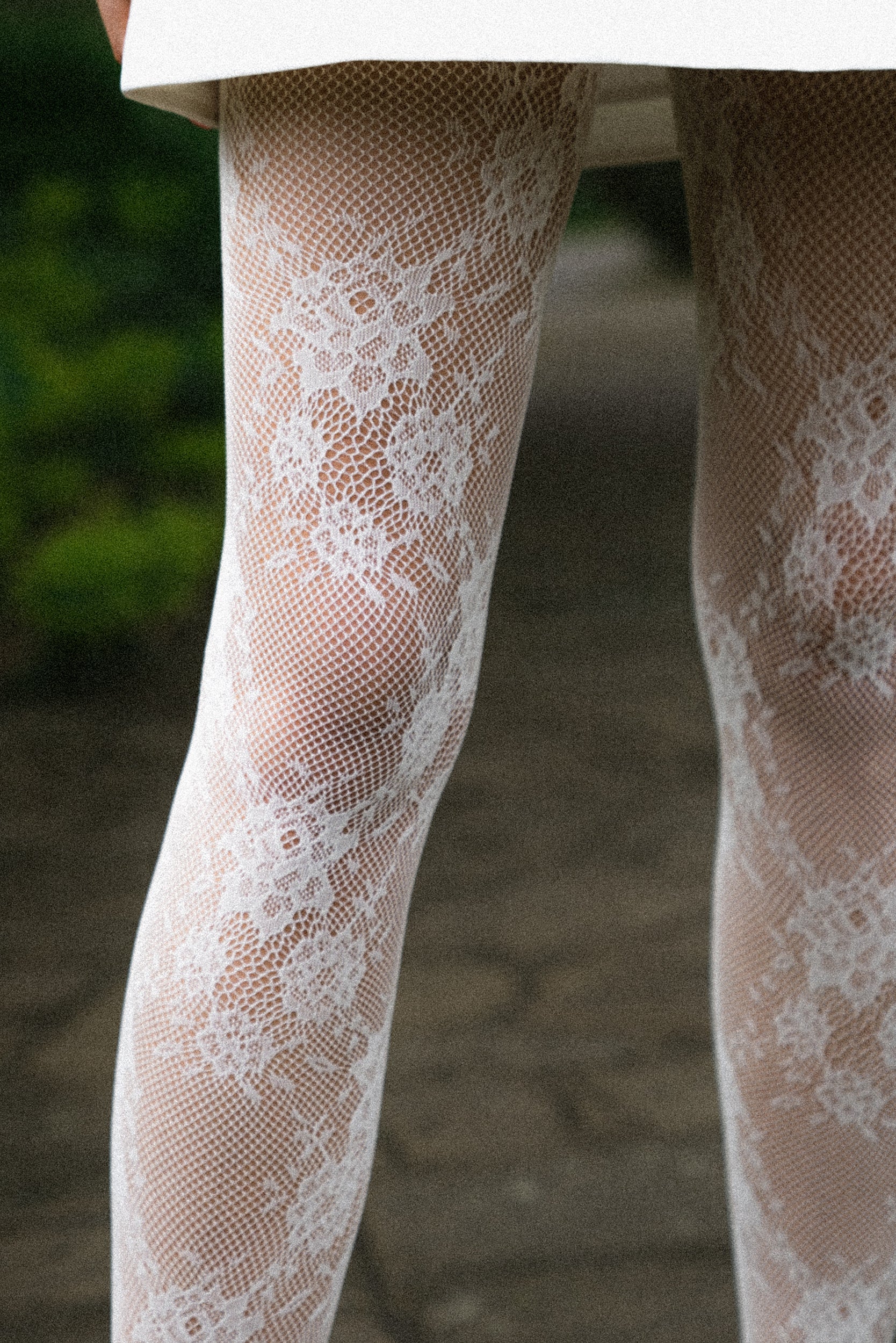 Floral lace tights with adaptive waistband and reinforced toe.